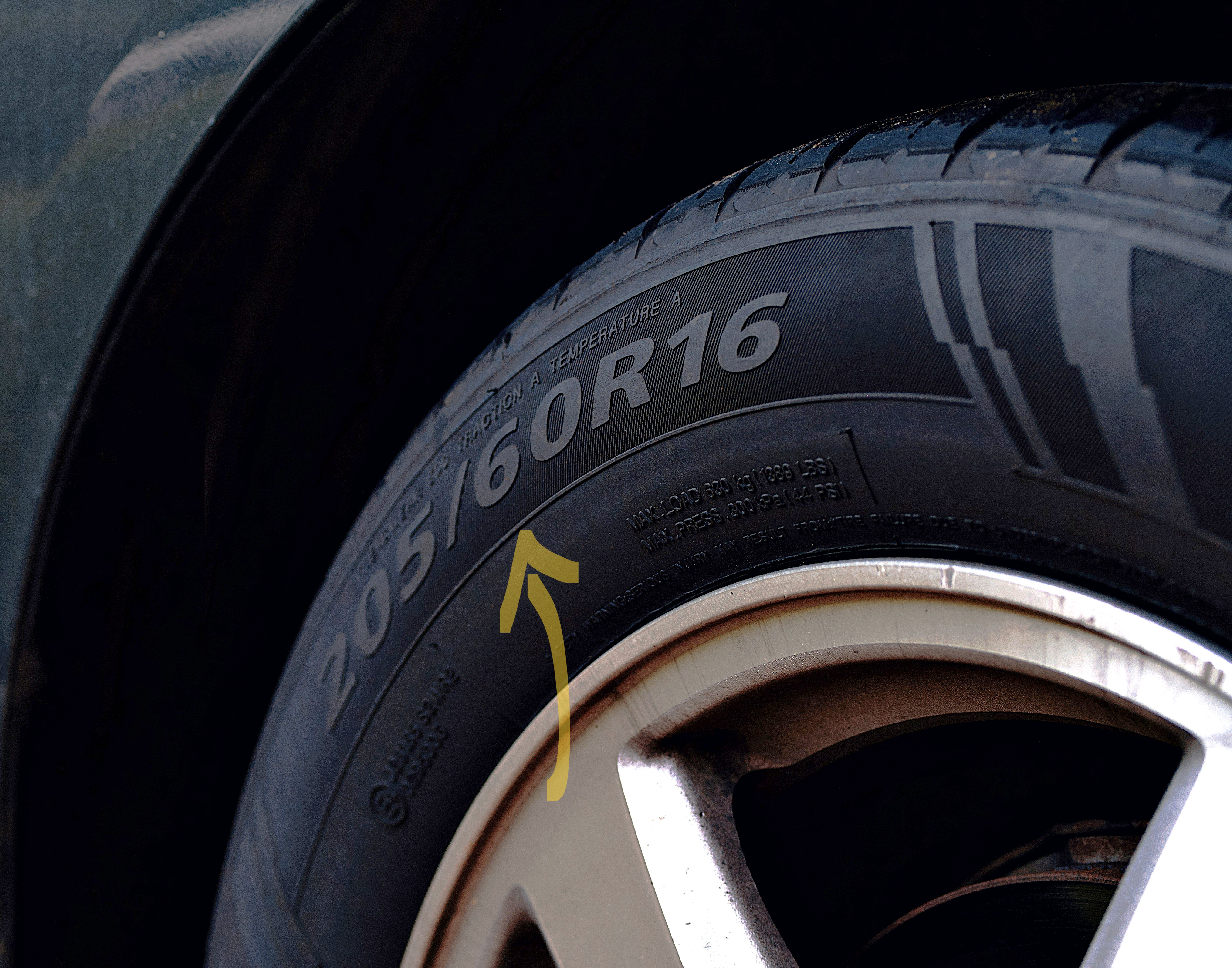 Close-up of a tire mounted on a wheel showing tire size marking